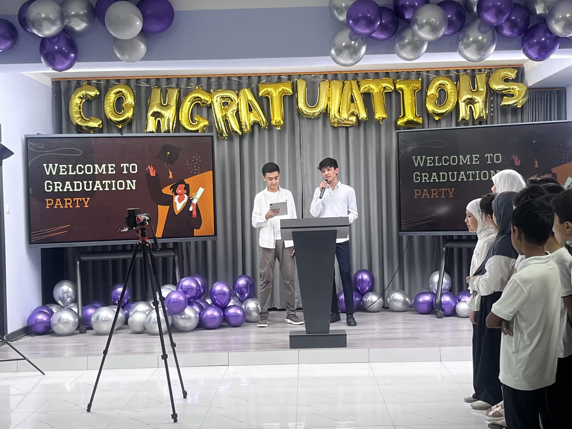 Two students speaking at the Dombit graduation ceremony